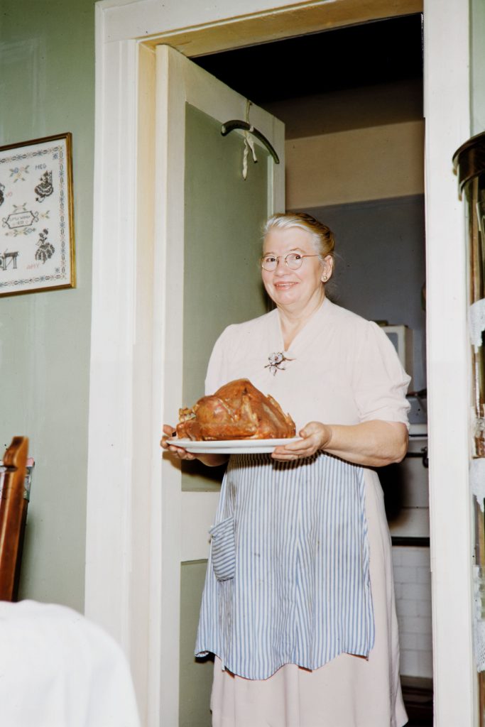 Barbara M. (Reinhard) Figueroa entering the dining room in Richmond Hill, photographed by her son James using color slides.  Scanned by her grandson James.